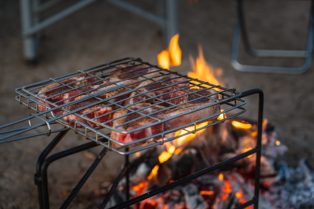 Charcoal grilling over an open fire at a campsite