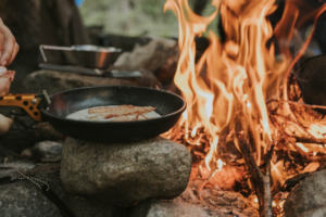 Camp breakfast cooking outdoors on a portable stove