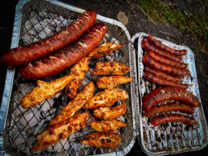 Chicken cooking on an outdoor barbecue grill