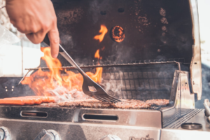 Steak grilling over high heat on an outdoor barbecue