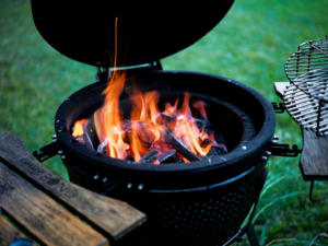 Glowing charcoal in an outdoor grill for comparing portable grill fuel types