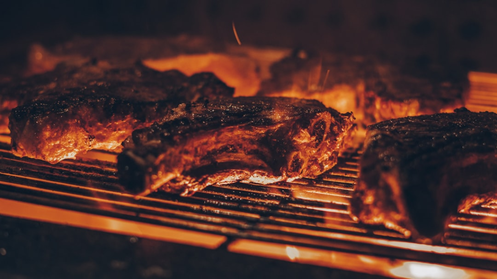 Steak grilling over direct and indirect heat zones